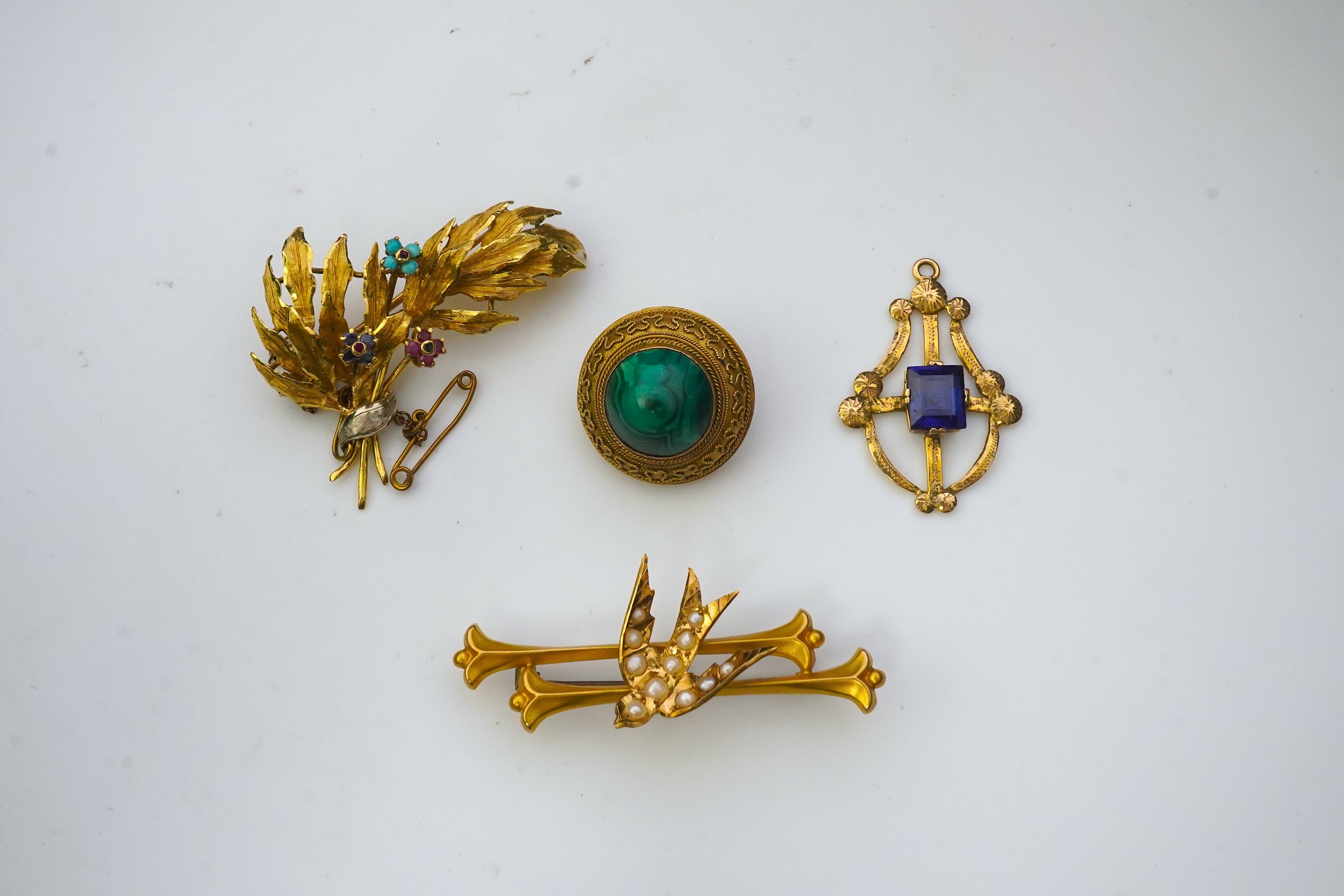 A collection of three brooches and a pendant, 19th and 20th century